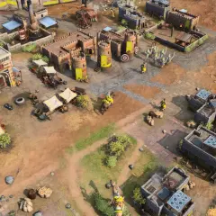 Widok z lotu ptaka na miasto w grze rts. Widać budynki, żołnierzy, wozy i rynek.