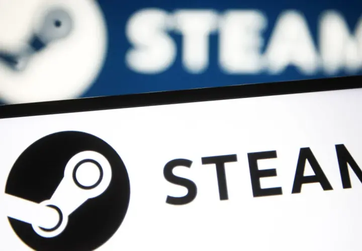 Awaria Steam. Logo platformy Steam na ekranie, w tle rozmyty, niebieski ekran z tym samym logo.