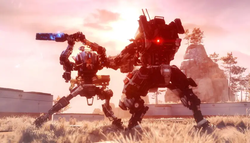 Dwa tytany w akcji, gotowe do walki w świecie Titanfall 3. Jeden z nich celuje bronią, drugi ma czerwone oko.