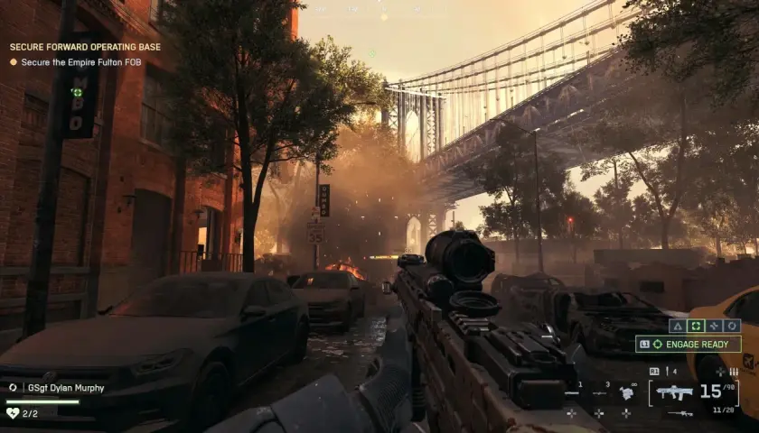 Wojna w mieście, płonące samochody i most w tle. To fragment kampanii Battlefield 6, gdzie gracz ma zabezpieczyć bazę.