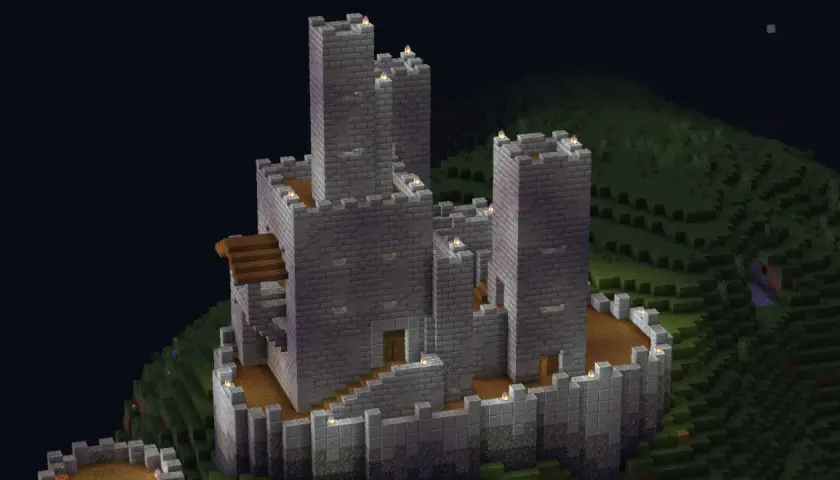 Potężny kamienny zamek z wieżami, dziedzińcem i schodami. To pokazuje, co można zbudować w Minecraft.