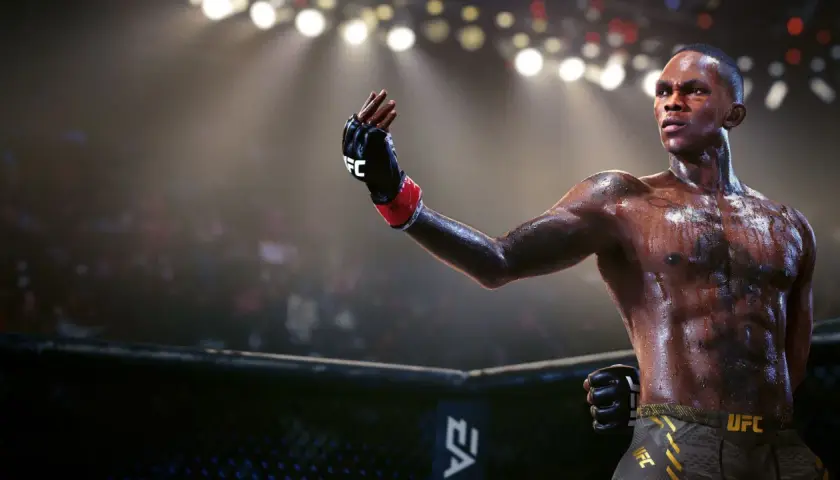 Izolowany zawodnik UFC w grze, spocony i gotowy do walki, unosi rękę w geście zwycięstwa.