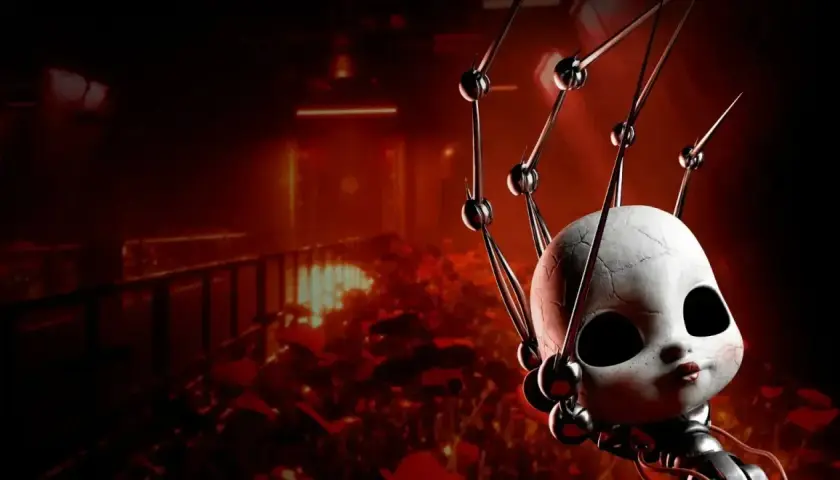 Przerażająca głowa lalki z pęknięciami, otoczona mechanicznymi ramionami, na tle mrocznego, czerwonego korytarza. Zapowiedź Poppy Playtime Chapter 5.