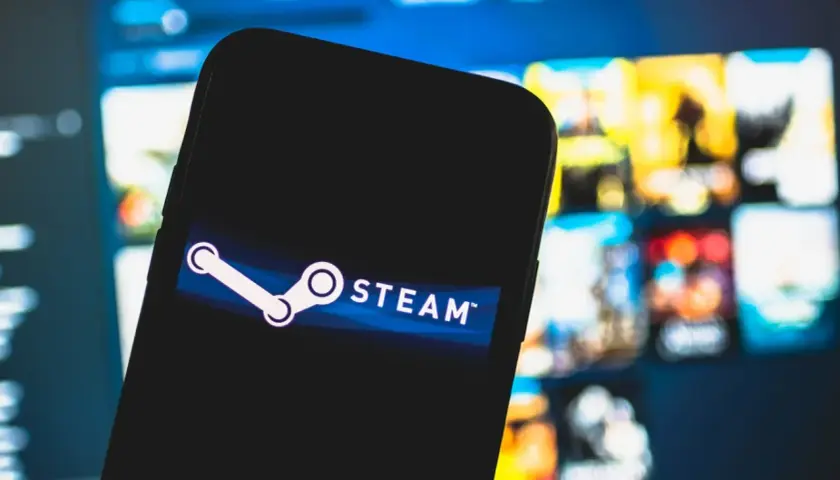 Telefon z logo Steam. Chcesz wiedzieć, jak sprawdzić ile się wydało na Steam? Zobaczysz tu podpowiedź.