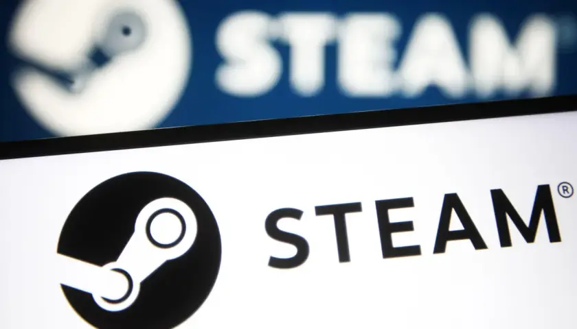 Awaria Steam. Logo platformy Steam na ekranie, w tle rozmyty, niebieski ekran z tym samym logo.