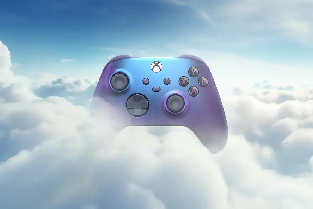 Kontroler Xboxa w tęczowych barwach unosi się wśród puszystych chmur, symbolizując granie w chmurze i nieograniczone możliwości.