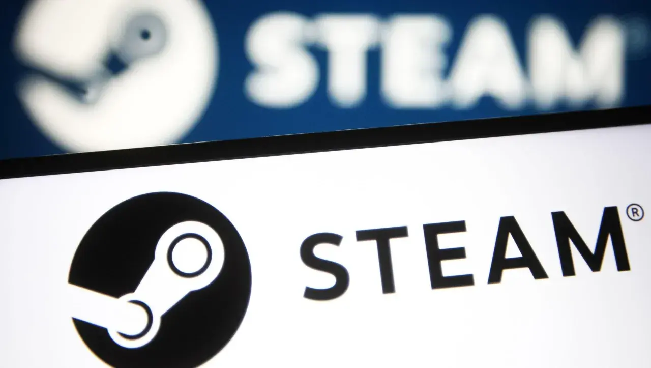 Awaria Steam. Logo platformy Steam na ekranie, w tle rozmyty, niebieski ekran z tym samym logo.