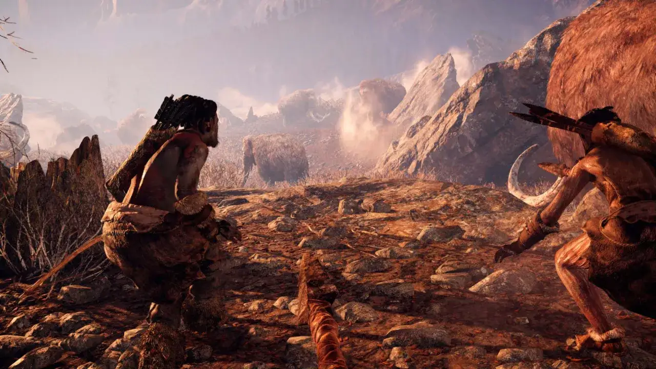 Dwóch wojowników z epoki kamienia przygotowuje się do walki z mamutem. Wymagania Far Cry Primal są wysokie, by cieszyć się taką grafiką.