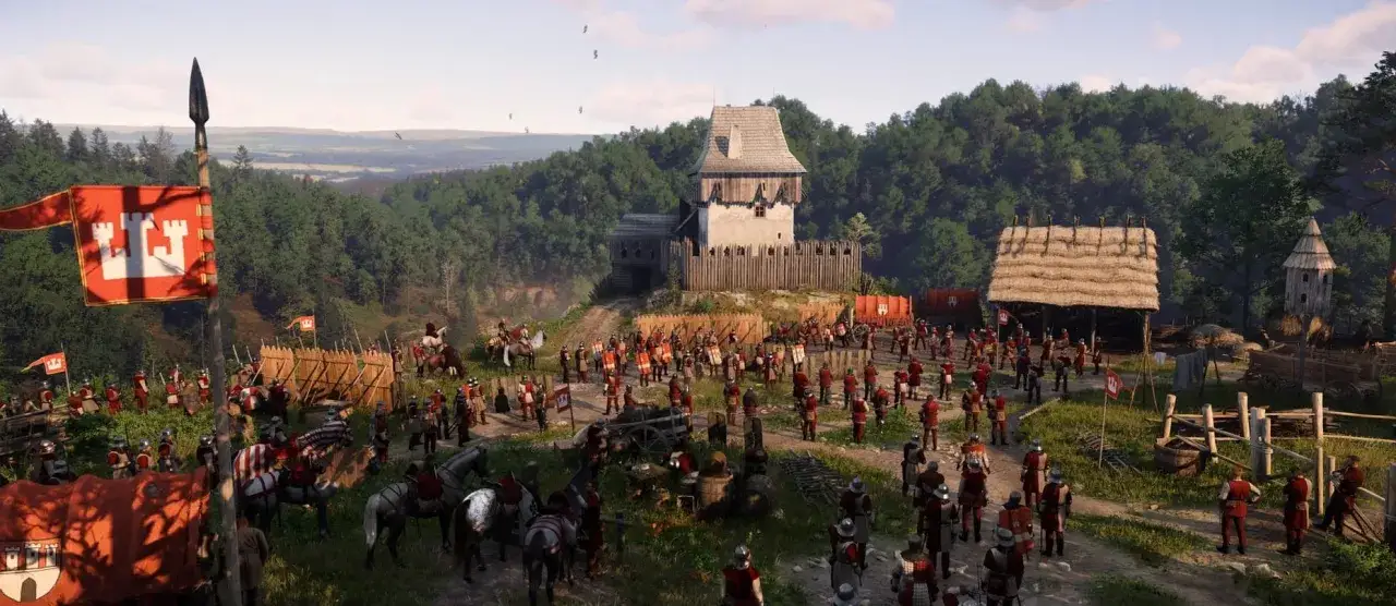 Armia w grze od Warhorse Studios szykuje się do bitwy. Żołnierze w czerwonych zbrojach i rycerze na koniach stoją przed drewnianą fortecą.